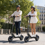 Two adults riding SUNNIGOO G7 ABE electric scooters together on a city street